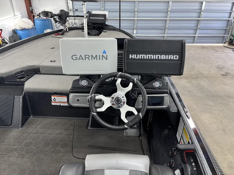 Slide: The Image of 2023 Nitro Z20 Pro boat dashboard with Garmin and Humminbird displays in a garage setting. - 18
