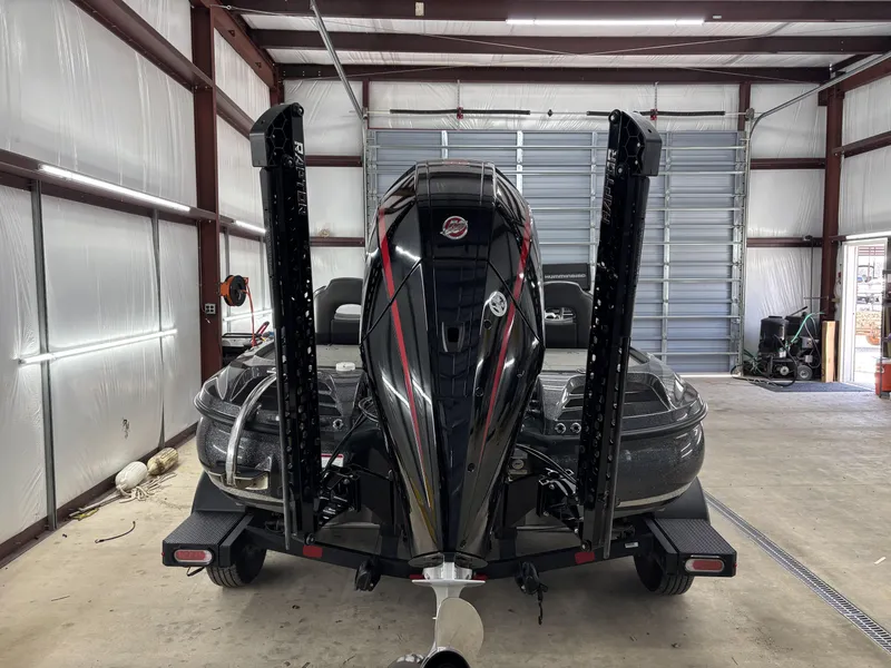 Slide: The Image of 2023 Nitro Z20 Pro boat in a garage, rear view with motor and trailer. - 5