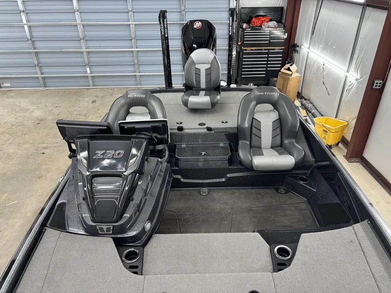 Slide: The Image of 2023 Nitro Z20 Pro boat interior with dual seats and control panel in a garage. - 9