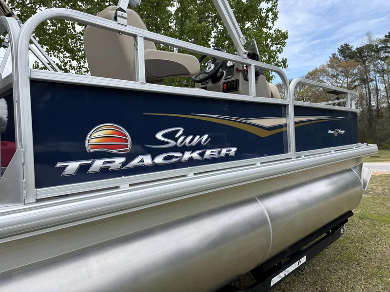 Slide: The Image of 2025 Sun Tracker Bass Buggy 16 XL Select pontoon boat, side view with logo. - 10
