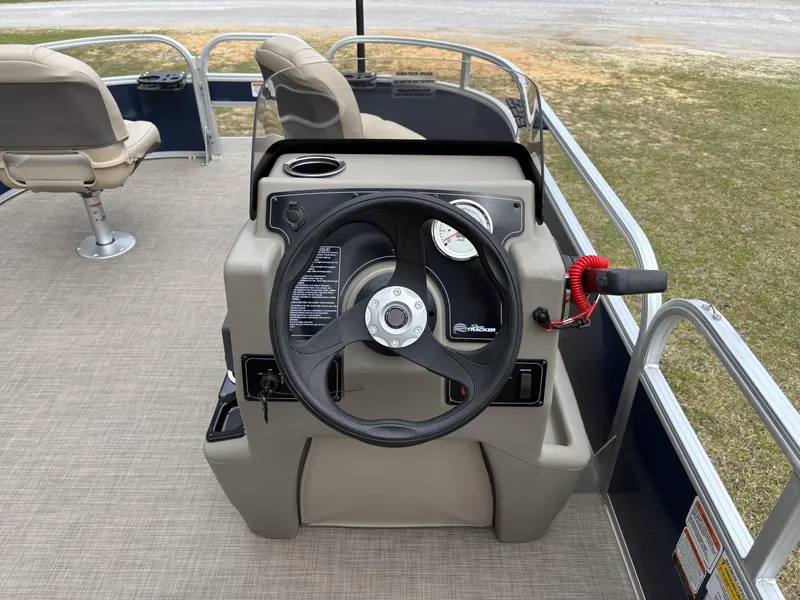 Slide: The Image of 2025 Sun Tracker Bass Buggy 16 XL Select steering console with beige seating. - 12