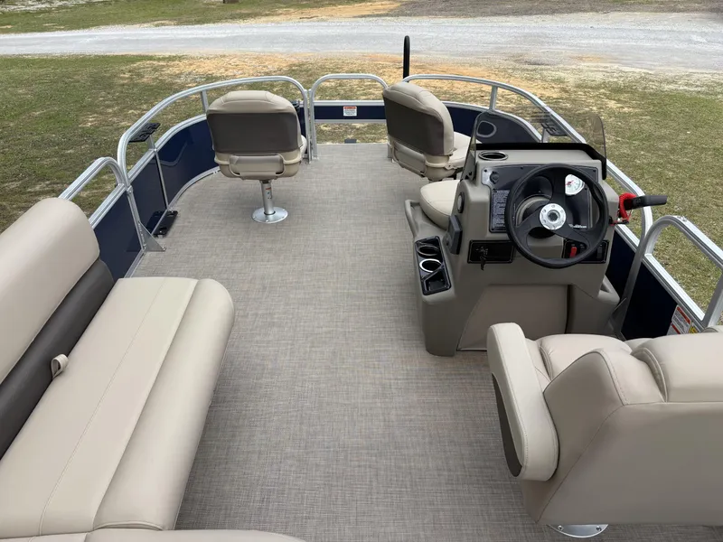 Slide: The Image of 2025 Sun Tracker Bass Buggy 16 XL Select pontoon boat interior with beige seating and steering console. - 13