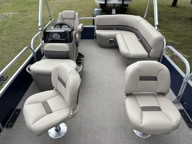 Slide: The Image of 2025 Sun Tracker Bass Buggy 16 XL Select pontoon boat with beige seating and spacious layout. - 6
