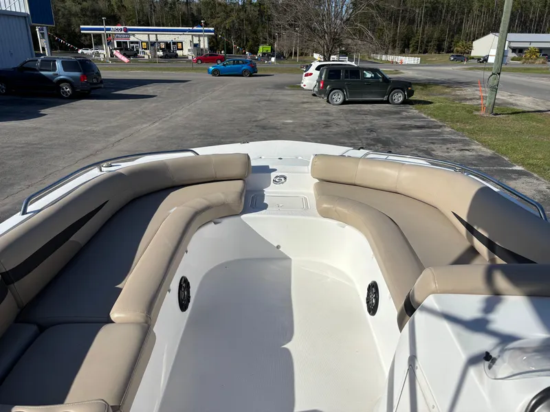 Slide: The Image of 2021 Hurricane SS 201 boat with beige seating, parked near a gas station. - 19