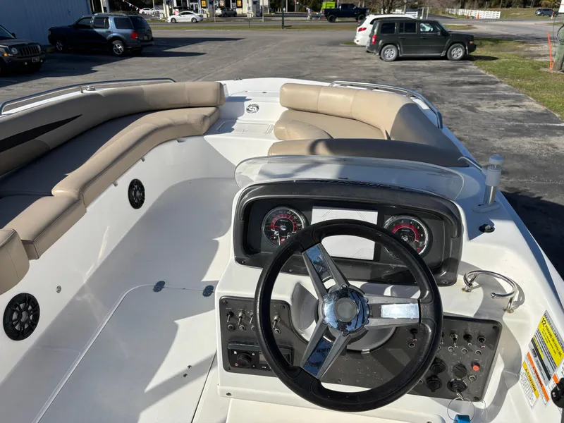 Slide: The Image of 2021 Hurricane SS 201 boat interior with steering wheel and seating area. - 20