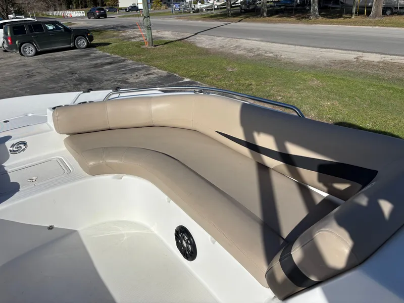 Slide: The Image of 2021 Hurricane SS 201 boat with beige seating, parked near a road. - 21