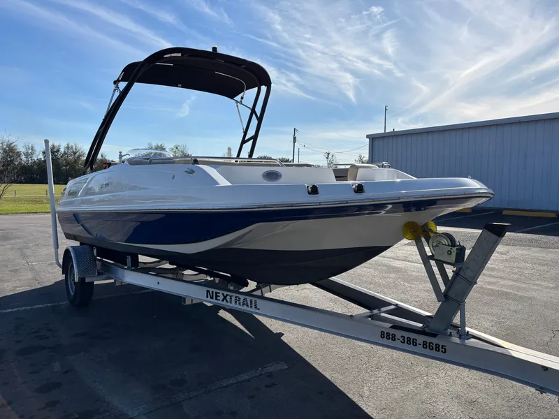 Slide: The Image of 2021 Hurricane SS 201 boat on trailer, blue and white, parked outdoors. - 3