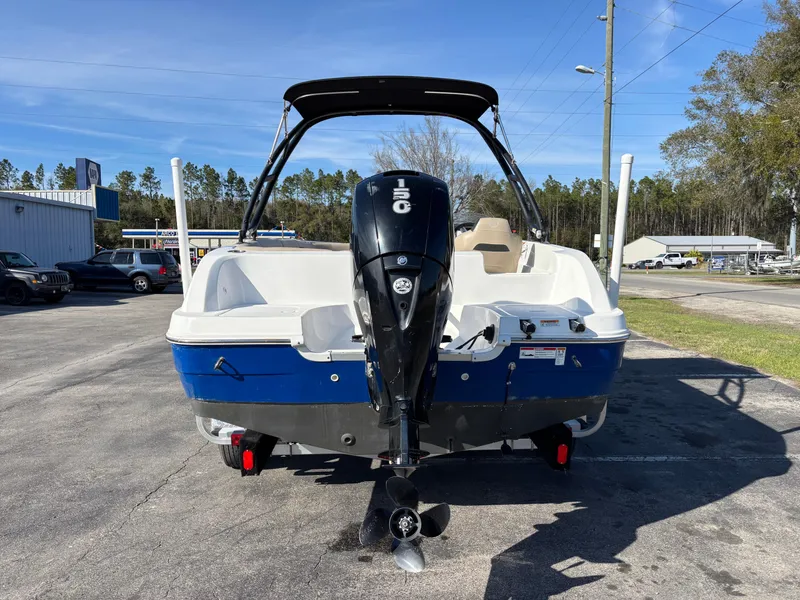 Slide: The Image of 2021 Hurricane SS 201 boat with outboard motor, parked outdoors on a sunny day. - 6