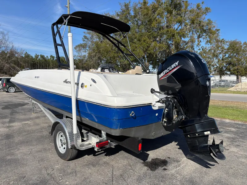 Slide: The Image of 2021 Hurricane SS 201 boat with Mercury outboard motor on a trailer. - 7