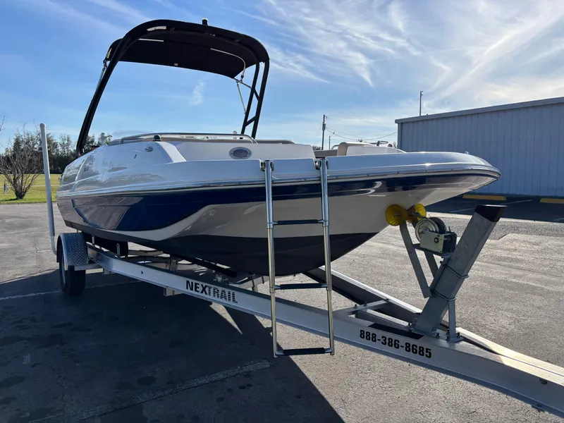 Slide: The Image of 2021 Hurricane SS 201 boat on trailer, parked outdoors under clear sky. - 9