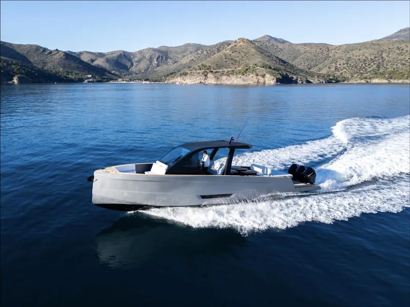 Slide: The Image of 2025 Maxim Yachts MAX44R cruising on serene blue waters with scenic mountain backdrop. - 0