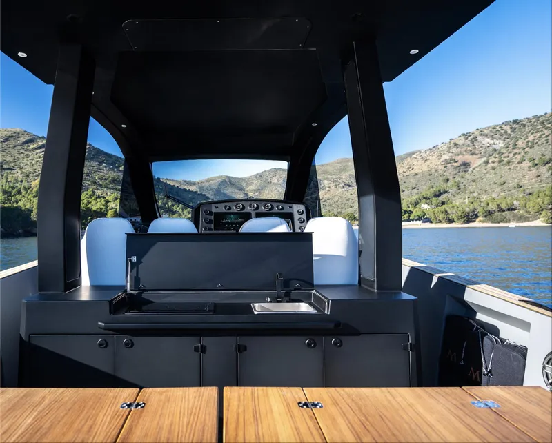 Slide: The Image of 2025 Maxim Yachts MAX44R interior with sleek design, featuring a modern kitchen area. - 13
