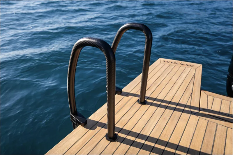 Slide: The Image of Luxury yacht swim platform with ladder, Maxim Yachts MAX44R 2025, on serene blue water. - 14