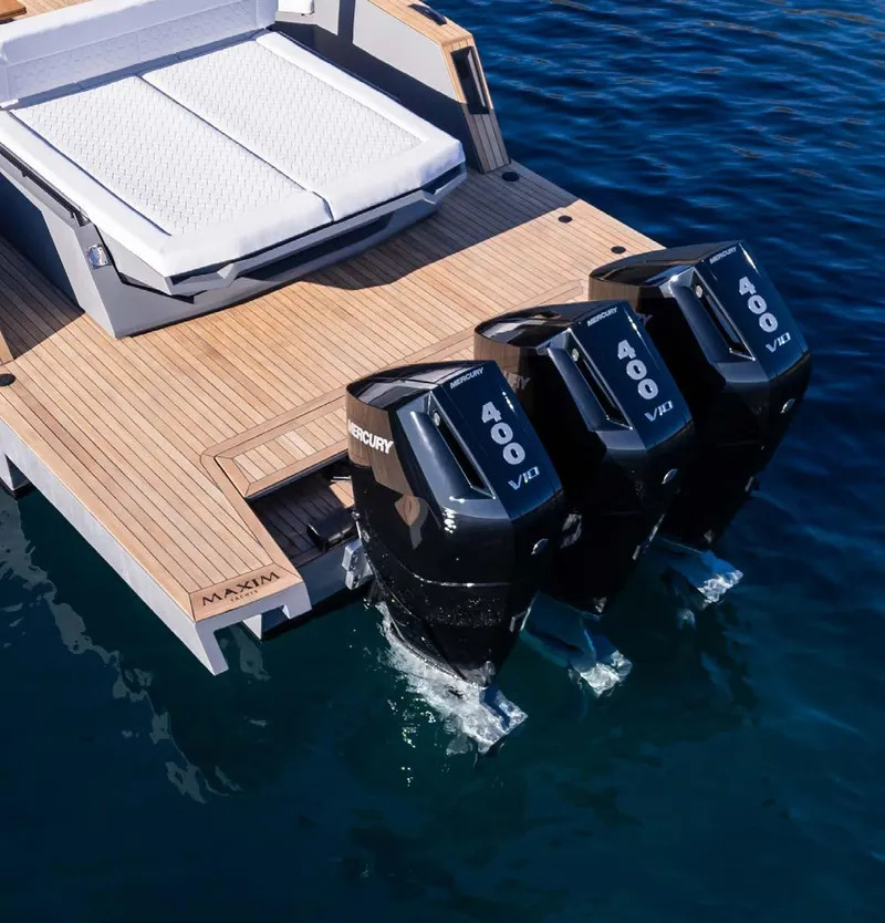 Slide: The Image of 2025 Maxim Yachts MAX44R with triple Mercury 400 engines on a sleek wooden deck. - 16