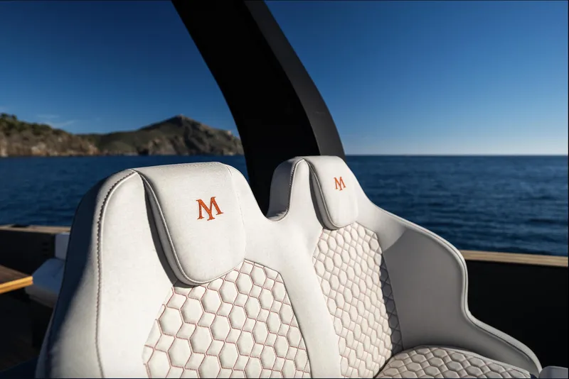 Slide: The Image of Luxury seating on 2025 Maxim Yachts MAX44R, featuring elegant design and ocean backdrop. - 18