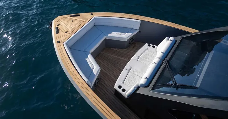 Slide: The Image of 2025 Maxim Yachts MAX44R boat with sleek seating and wooden deck on blue water. - 25