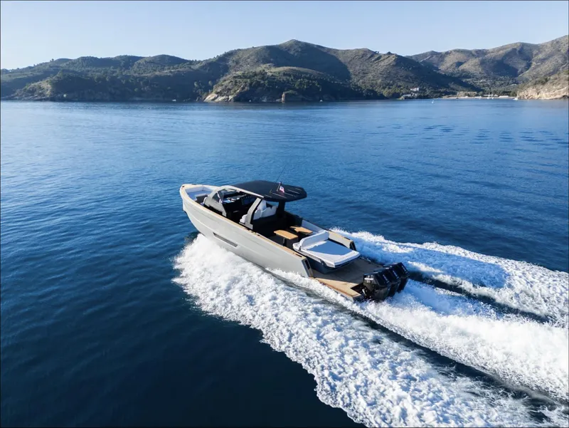 Slide: The Image of 2025 Maxim Yachts MAX44R cruising on serene blue waters near scenic mountains. - 7