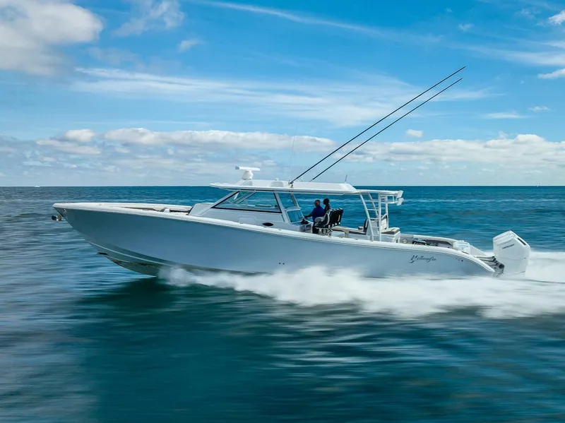 Slide: The Image of 2024 Yellowfin 54 Offshore boat cruising on open water under a clear blue sky. - 11