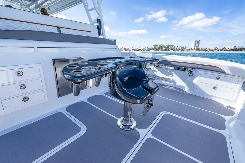 Slide: The Image of 2024 Yellowfin 54 Offshore boat deck with fishing rod holders and storage compartments. - 18