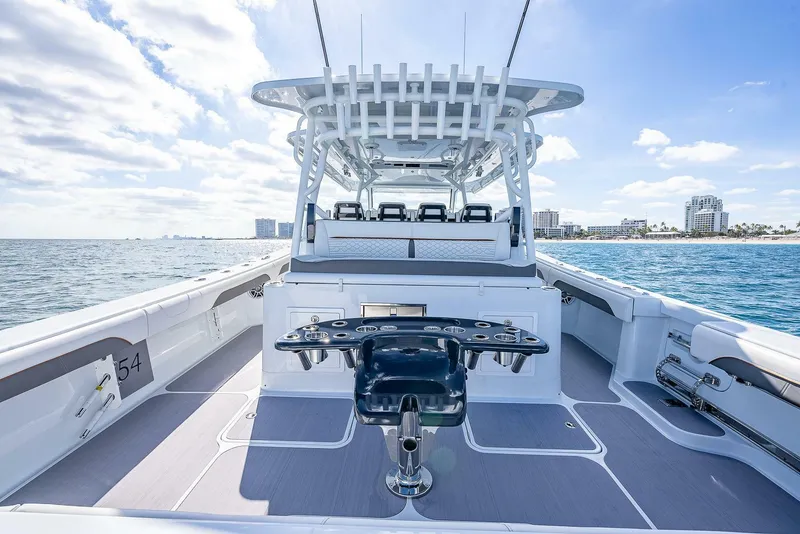 Slide: The Image of 2024 Yellowfin 54 Offshore boat, spacious deck, ocean view, clear sky, modern design. - 19