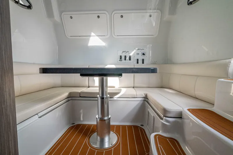 Slide: The Image of 2024 Yellowfin 54 Offshore cabin interior with seating and table. - 29