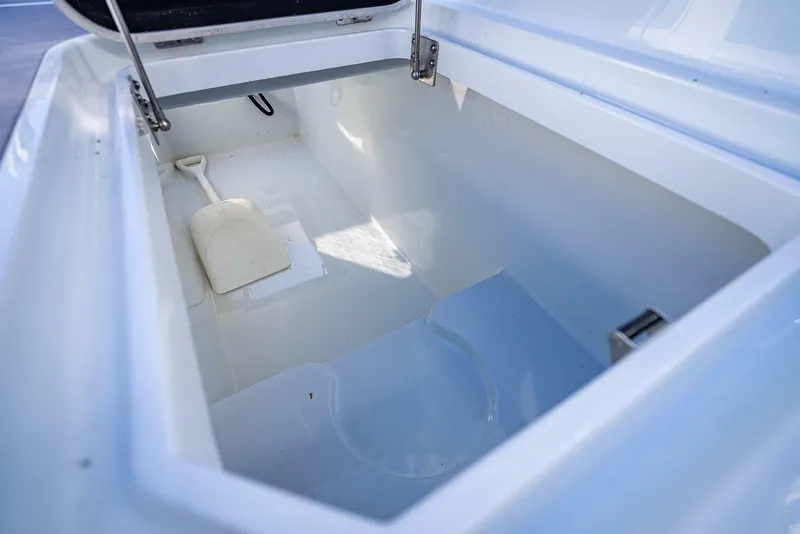 Slide: The Image of 2024 Yellowfin 54 Offshore storage compartment, open lid, spacious interior. - 38