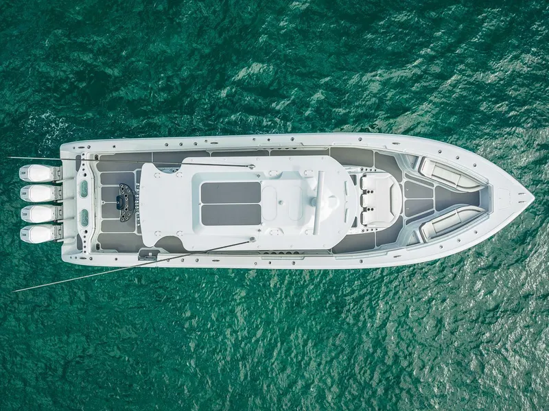 Slide: The Image of 2024 Yellowfin 54 Offshore boat on clear blue water, aerial view. - 8