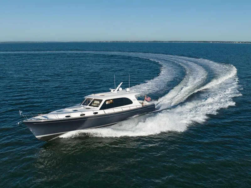 Slide: The Image of 2026 Eastbay EB60 yacht cruising on open water, creating a dynamic wake. - 2