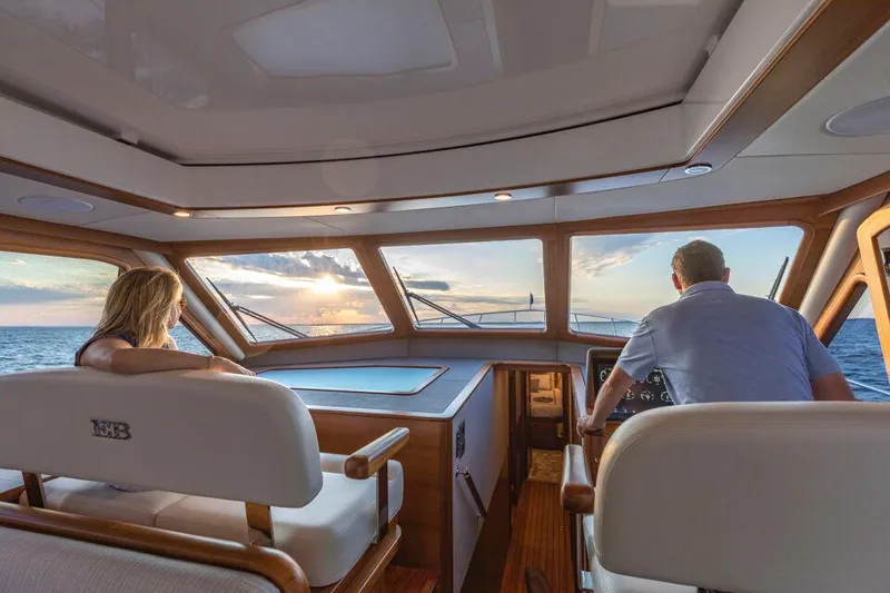 Slide: The Image of Interior view of 2026 Eastbay EB60 yacht with two people enjoying the ocean view. - 23