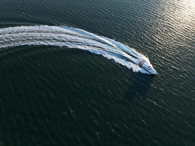 Slide: The Image of Aerial view of 2026 Eastbay EB60 yacht making a sharp turn on open water. - 7