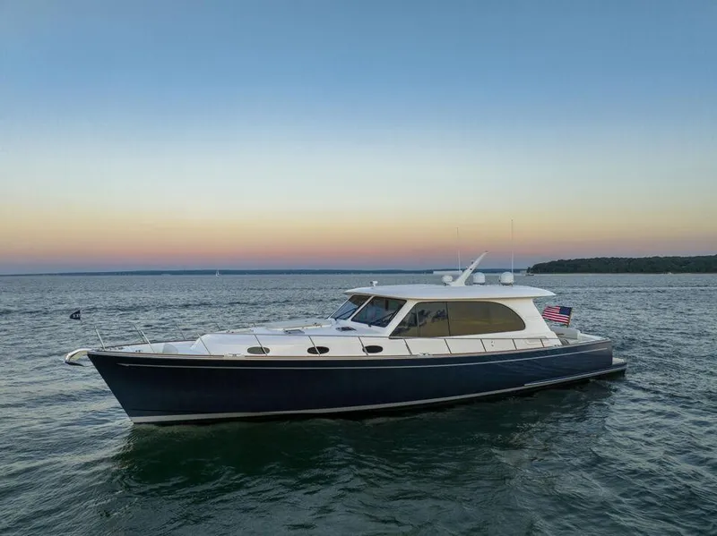 Slide: The Image of Eastbay EB60 2026 yacht cruising on serene waters at sunset. - 1