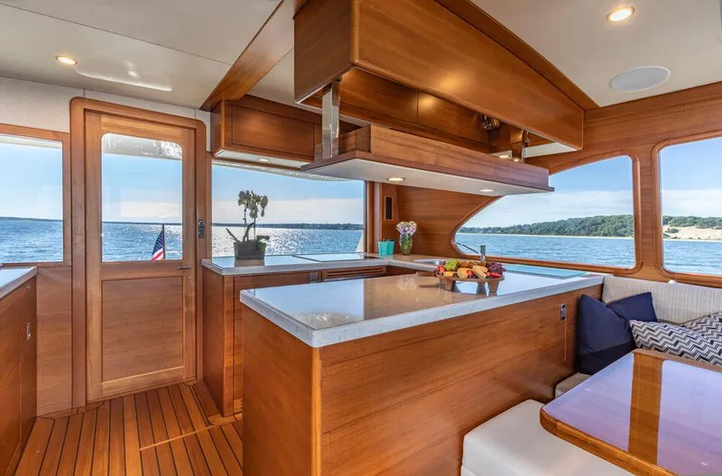 Slide: The Image of Luxurious interior of 2026 Eastbay EB60 yacht with wooden finishes and ocean view. - 15