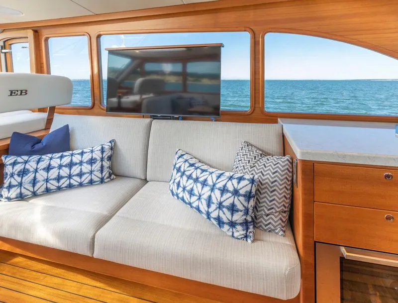Slide: The Image of Luxurious Eastbay EB60 yacht interior with ocean view, featuring a comfortable sofa and stylish cushions. - 21
