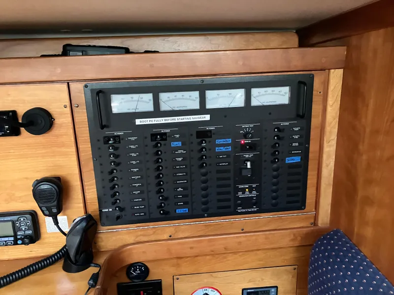 Slide: The Image of Electrical control panel on a 1997 Sabre 402 yacht, featuring gauges and switches. - 11