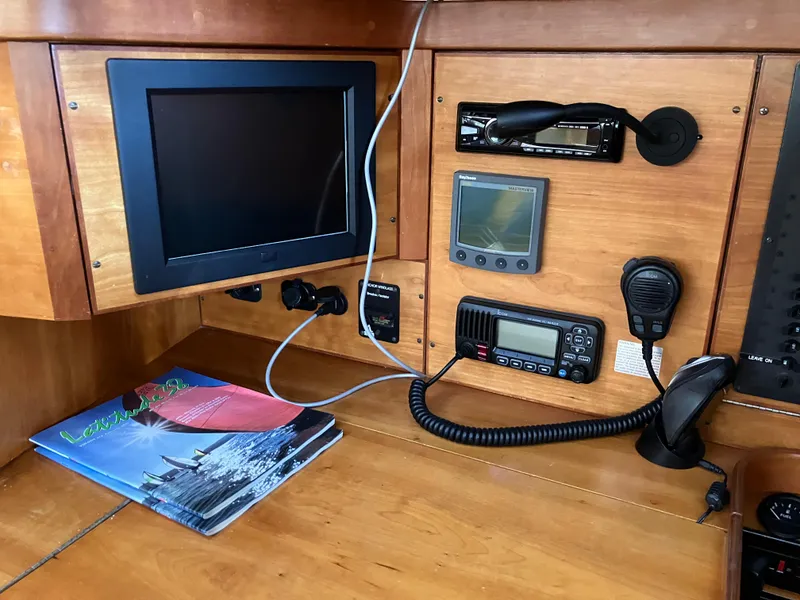 Slide: The Image of Navigation equipment and controls inside a 1997 Sabre 402 sailboat cabin. - 12