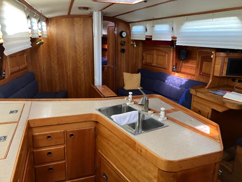 Slide: The Image of Interior of a 1997 Sabre 402 yacht with wooden cabinetry and modern amenities. - 14