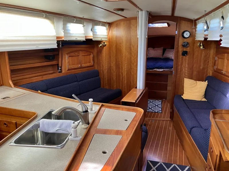 Slide: The Image of Interior of a 1997 Sabre 402 yacht with wood finish and cozy seating. - 16
