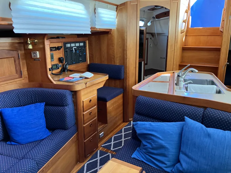 Slide: The Image of Interior of 1997 Sabre 402 yacht with wood finish and blue upholstery. - 17