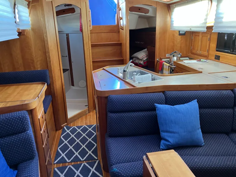 Slide: The Image of Interior of a 1997 Sabre 402 yacht with cozy seating and wooden cabinetry. - 18