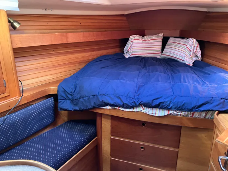 Slide: The Image of Cozy cabin interior of a 1997 Sabre 402 sailboat with wooden finish and blue bedding. - 20