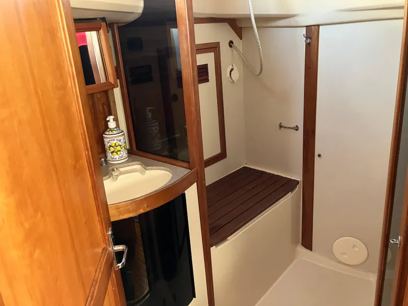 Slide: The Image of 1997 Sabre 402 yacht bathroom with wooden accents and compact sink. - 21