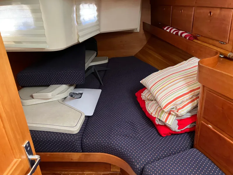 Slide: The Image of Cozy cabin interior of a 1997 Sabre 402 sailboat with cushions and pillows. - 22