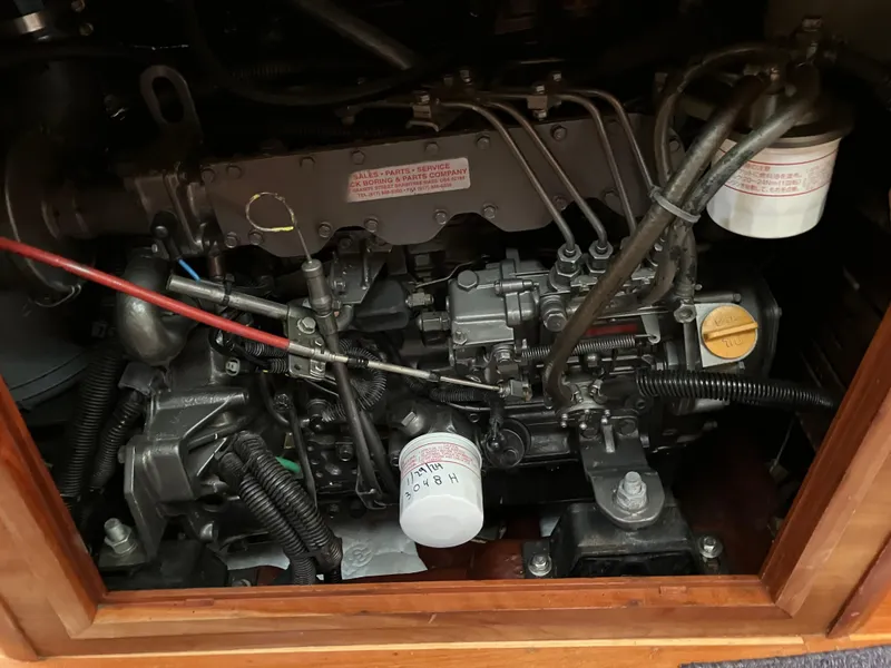 Slide: The Image of Engine compartment of a 1997 Sabre 402, showcasing mechanical components and wiring. - 23