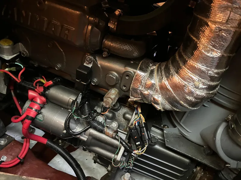 Slide: The Image of Engine components of a 1997 Sabre 402, featuring wiring and metallic tubing. - 24