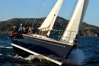 Slide: The Image of Sailing Sabre 402 yacht from 1997 on open water with crew onboard. - 25