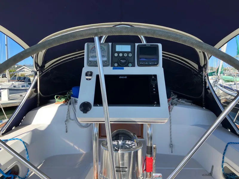 Slide: The Image of Cockpit of 1997 Sabre 402 sailboat with navigation instruments and steering wheel. - 8