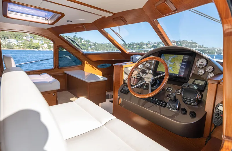 Slide: The Image of Interior of 2026 Palm Beach Motor Yachts PB45, featuring luxurious helm and seating. - 17
