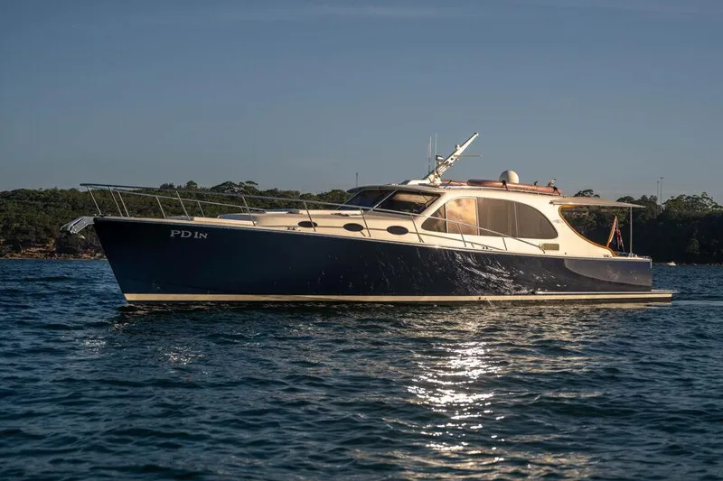 Slide: The Image of 2026 Palm Beach Motor Yachts PB45 cruising on calm waters at sunset. - 22