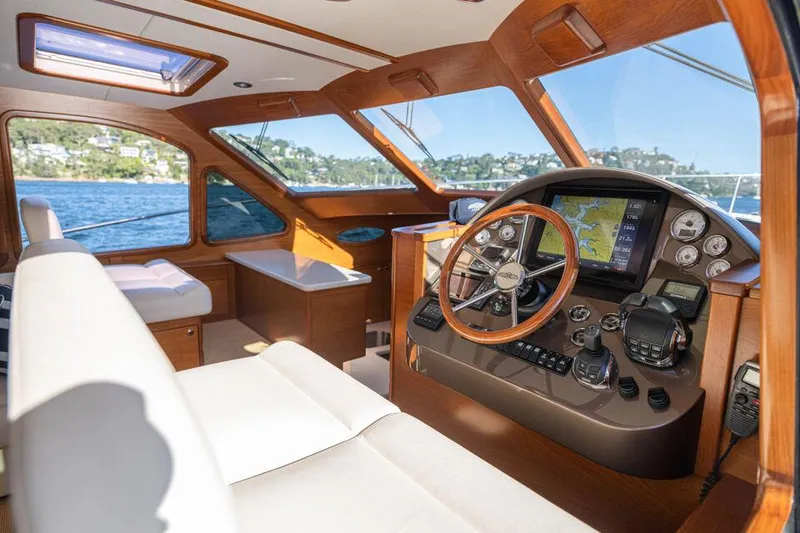 Slide: The Image of 2026 Palm Beach Motor Yachts PB45 interior with luxurious helm and panoramic windows. - 13