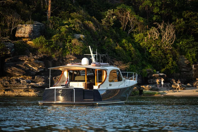 Slide: The Image of 2026 Palm Beach Motor Yachts PB45 cruising near a scenic shoreline. - 23
